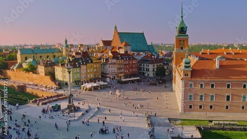 afternoon video of Old Town Warsaw in Poland with Castle Plaza filled with tourists and visitors and old architecture of Old Town 
