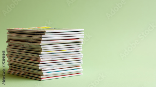 Stack of small comic books arranged in tidy pile on green background