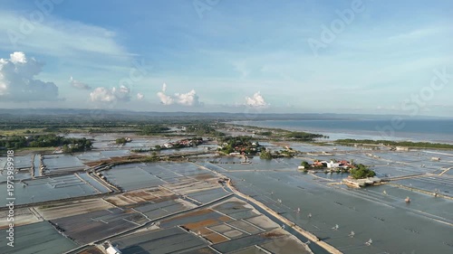 Aerial View of Salt Pans and Coastal Village Under Beautiful Dramatic Cloudy Sky