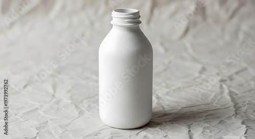 Minimalist white bottle presentation against textured white background