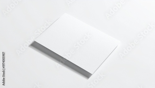 Blank white business cards stacked on a white surface, showcasing a clean and minimalist presentation with soft shadows