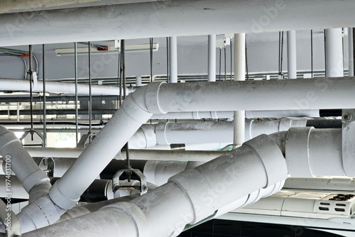 Bilde på lerret Plumbing pipes installed on a building ceiling.