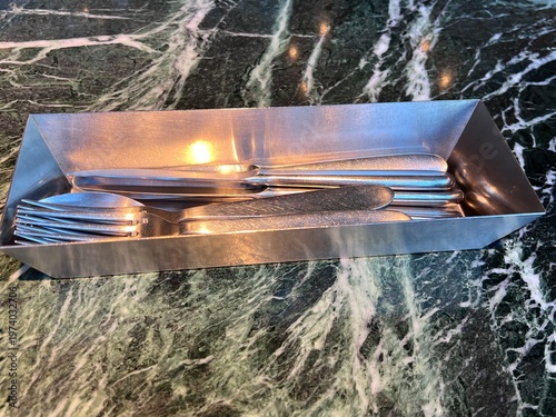 大理石模様のテーブルの上のスタイリッシュなフォークとナイフ