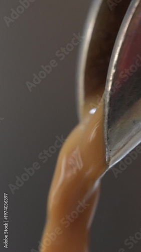 4K Vertical video Close-up of espresso flowing from coffee machine showing rich smooth liquid texture Fresh brewed coffee, Concept ideal for cafe barista and commercial beverage advertising.