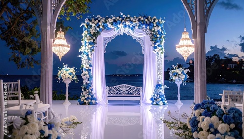 A beautiful decorated place for the wedding ceremony of the bride and groom in oriental style. Wedding arch made of white and blue fresh flowers.