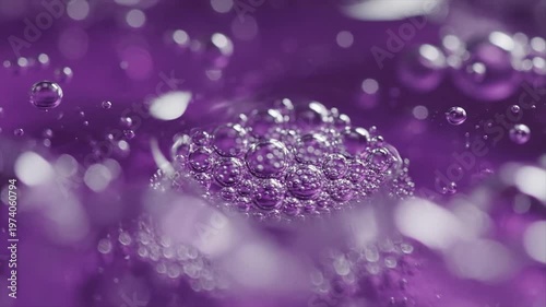 Sparkling water droplet impact in purple liquid with bokeh background