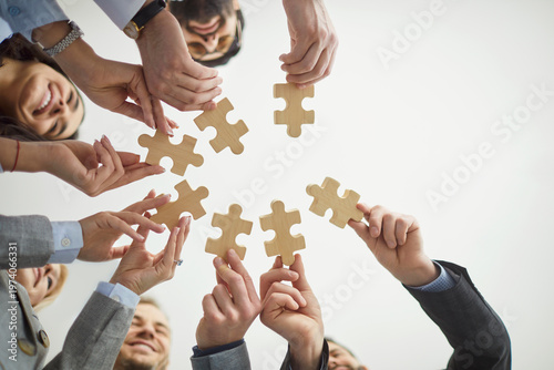 Cuadro en lienzo Jigsaw puzzles match, diverse colleagues holding wooden pieces, finding idea, se