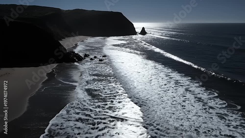 Dramatic Coastal Cliffs Meet Ocean Waves Under Sunlight.