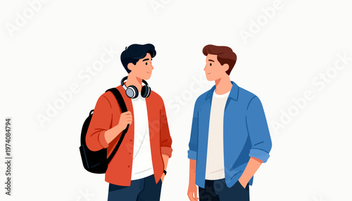 Two young men stand facing each other. One wears headphones and a backpack. The other smiles warmly, hands in pockets. They appear to chat casually, enjoying conversation. Perfect for student, friend
