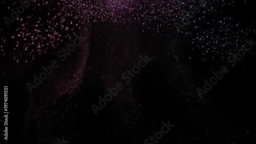 Abstract Pink and Purple Particles Exploding and Dispersing on a Black Background.