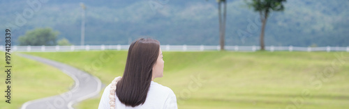 Relax and wellness concept with woman walk on road in garden and mountain background at chiangmai thailand in raining season