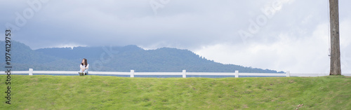 Relax and wellness concept with woman sit on road in garden and mountain background at chiangmai thailand in raining season
