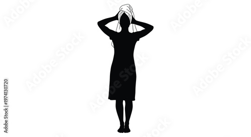 Woman with towel on head standing a striking black silhouette