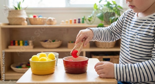 Child sorting pom poms with wooden tongs in Montessori setting
