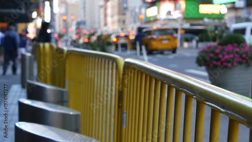 Manhattan Midtown street New York City, United States. Port authority bus terminal. Defocused car traffic on urban road, 8th avenue in Hells Kitchen. People pedestrian, yellow taxi. Sidewalk pavement.