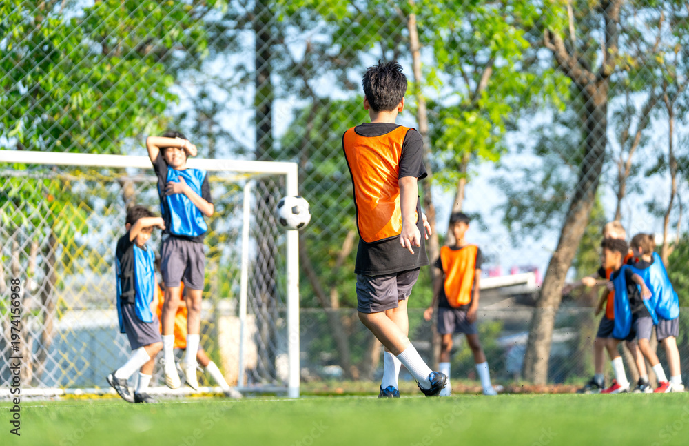Fototapeta premium Back of one player action of penalty shoot-out with protect by the opposite players in front of the goal of soccer in the field