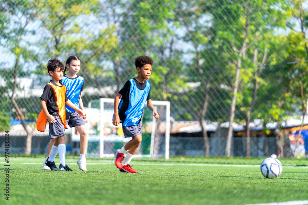 Obraz premium African American boy run straight to the soccer ball and prepare to kick or shoot the ball in the field with day light.