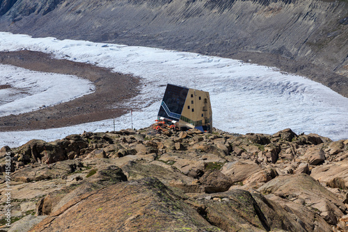 Panorama with mountain hut Monte Rosa Hut in front of glacier Grenzgletscher in Pennine Alps, Switzerland
