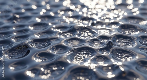 Close-up of water surface with light reflections.