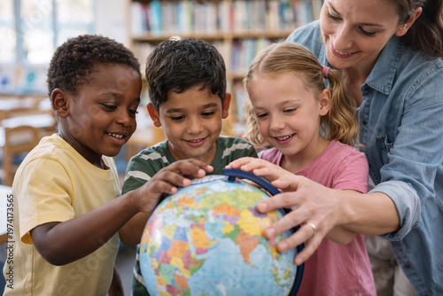 Curious children exploring globe together in classroom learning geography