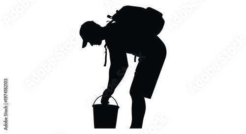Hiker bending to examine a bucket depicted in striking black silhouette