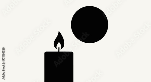 Black candle with flame burning bright.
