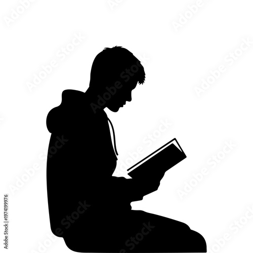 A silhouette of a young boy sitting and reading a book intently silhouette