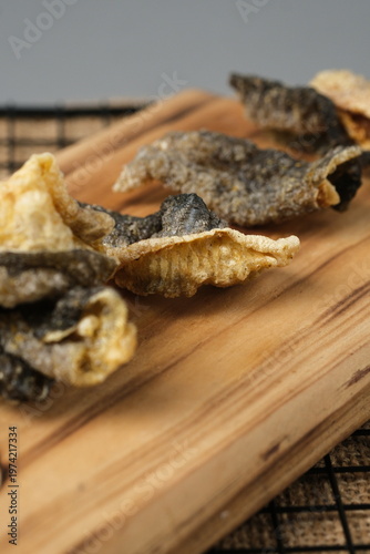Crispy salmon skin snacks on a wooden board  burlap. Perfect for food blogs, restaurant menus, seafood advertisements, or culinary websites.