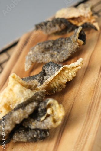 Crispy salmon skin snacks on a wooden board  burlap. Perfect for food blogs, restaurant menus, seafood advertisements, or culinary websites.