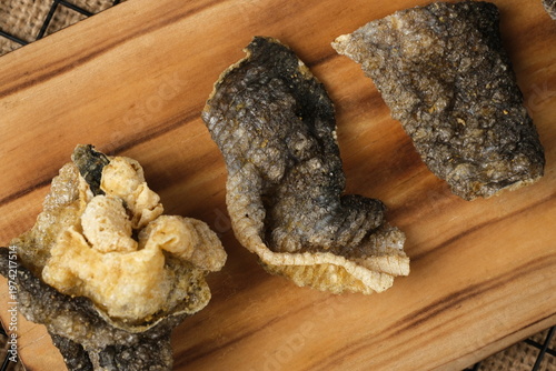 Crispy salmon skin snacks on a wooden board  burlap. Perfect for food blogs, restaurant menus, seafood advertisements, or culinary websites.