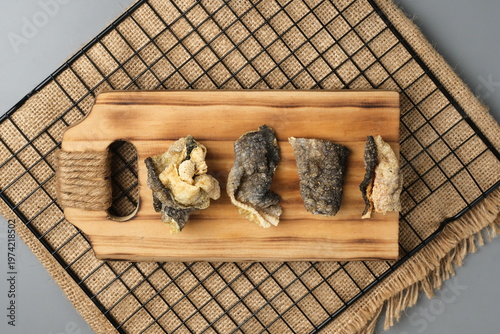 Crispy salmon skin snacks on a wooden board  burlap. Perfect for food blogs, restaurant menus, seafood advertisements, or culinary websites.