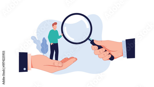 Large business hand holds a magnifying glass over a small professional standing in another hand for a talent search concept.