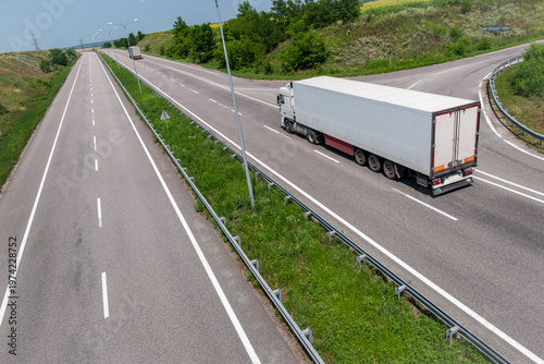 White truck driving on highway on summer day