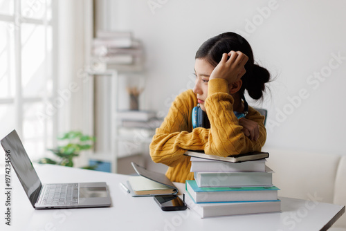 Bild auf Leinwand Young female student feeling stressed and overwhelmed by studying