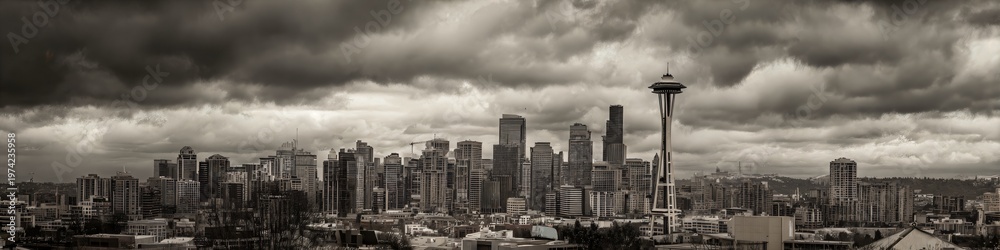 Fototapeta premium Seattle Skyline Panorama: A stunning panoramic view of Seattle's iconic skyline under a dramatic, cloud-filled sky, capturing the city's urban grandeur and unique architectural blend.