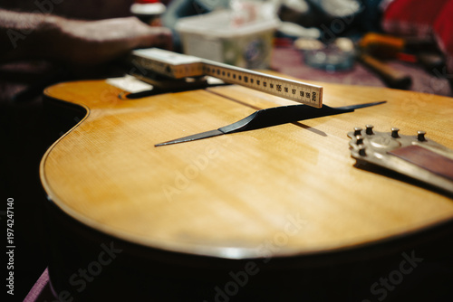 Acoustic guitar repair with tools around it