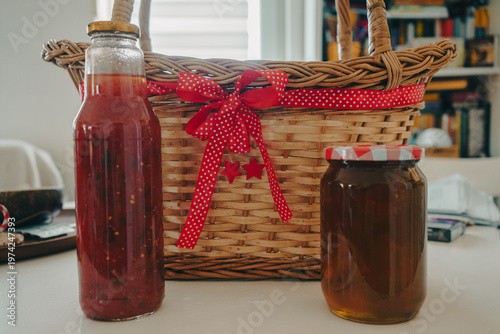 Tomato juice and jars of jam on the table
