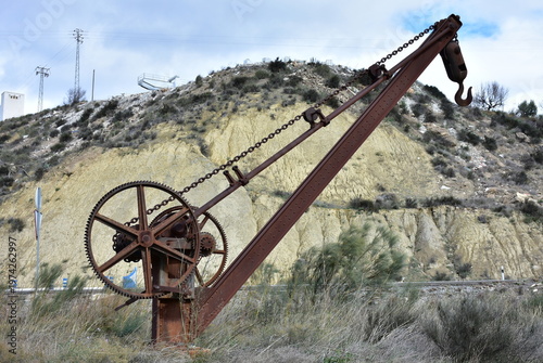 old and rusted railway crane in village Fines,Spain