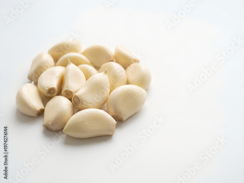 fresh peeled garlic on white surface background