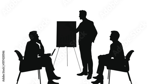 Business professional leads a presentation to two colleagues in a small meeting with an easel and laptop.