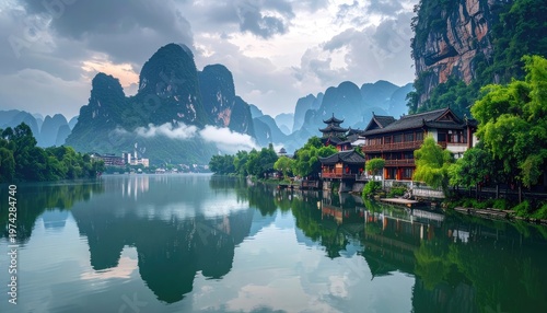 A serene landscape showcases traditional Chinese architecture nestled along a tranquil river, framed by towering karst mountains and a misty sky.