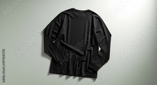 Flat lay of a plain black long-sleeved t-shirt, showcasing its simple design and comfortable fabric