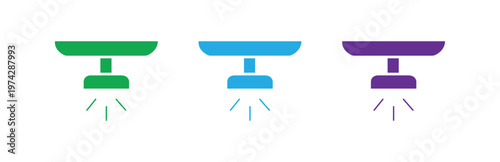 A set of simple flat design icons representing spotlights or ceiling lights in green blue and purple isolated on a white background for various design applications.