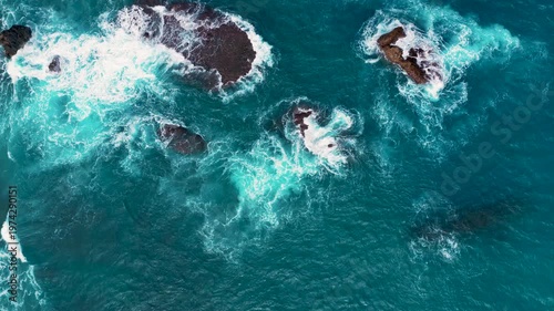 Aerial view of Waves on the beach and rock