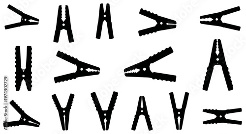 Collection of various black plastic clothespins on white background for laundry and drying needs