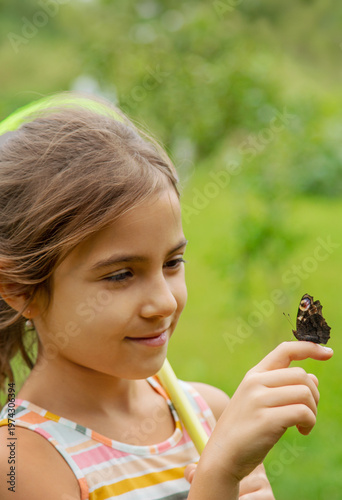 The child catches butterflies in nature. Selective focus. ,