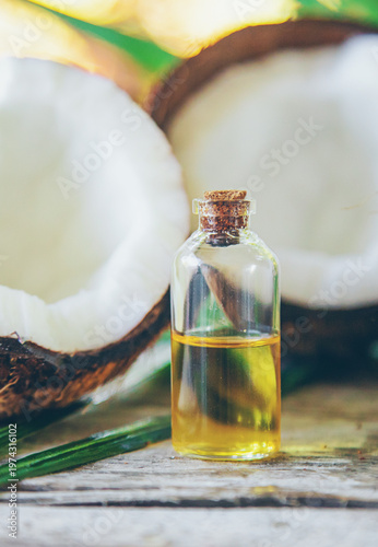 Natural coconut oil in a bottle. Selective focus.