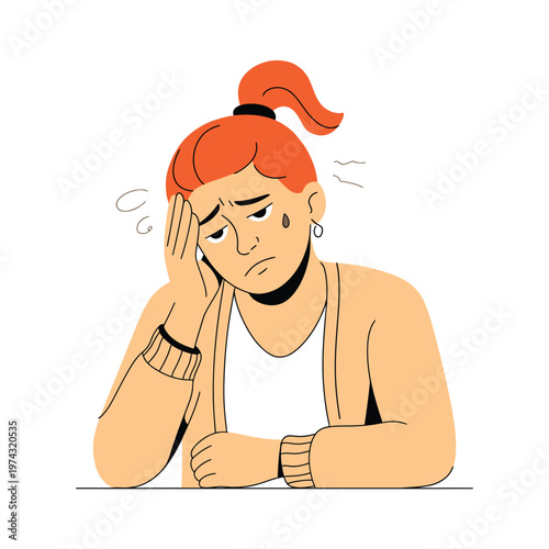 A stressed woman with red hair sitting at a table looking worried