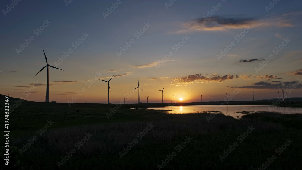 Obraz premium Windmills turbines at sunset