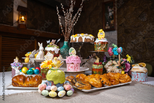 Festive Easter Table with Decorated Kulichi, Bunny Figurines and Colored Eggs